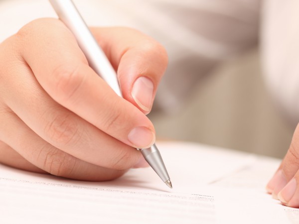 Businesswoman viewing the contract before signing